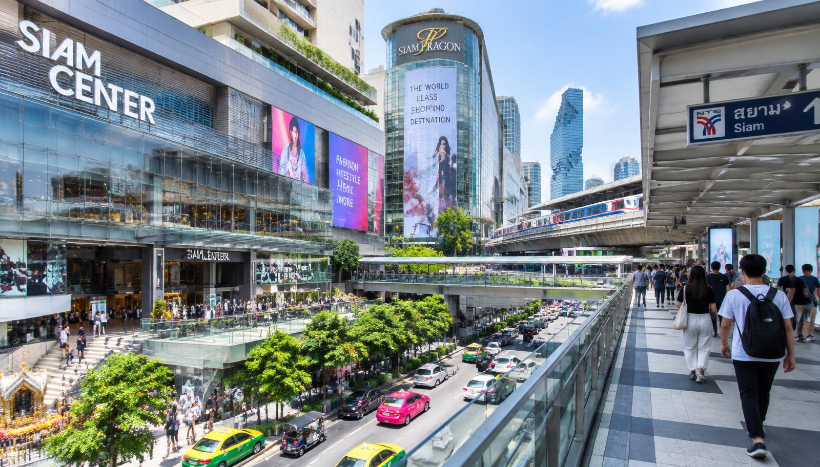 The Siam shopping district in Bangkok with a busy skywalk, modern malls and the BTS Skytrain