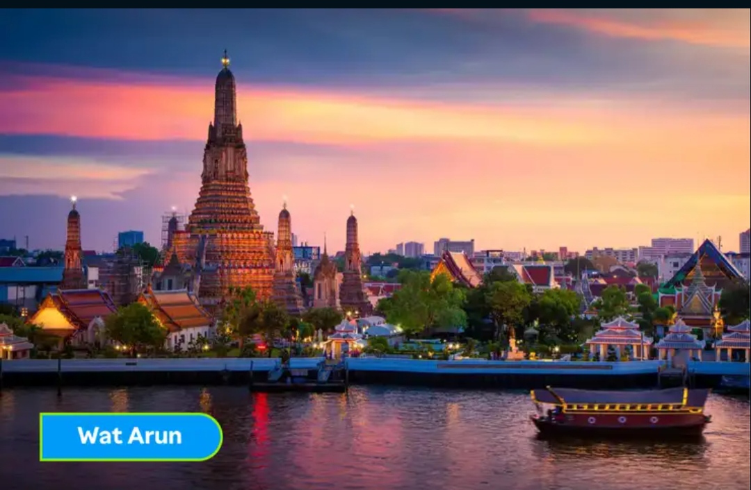 Wat Arun glowing at sunset beside the Chao Phraya River
