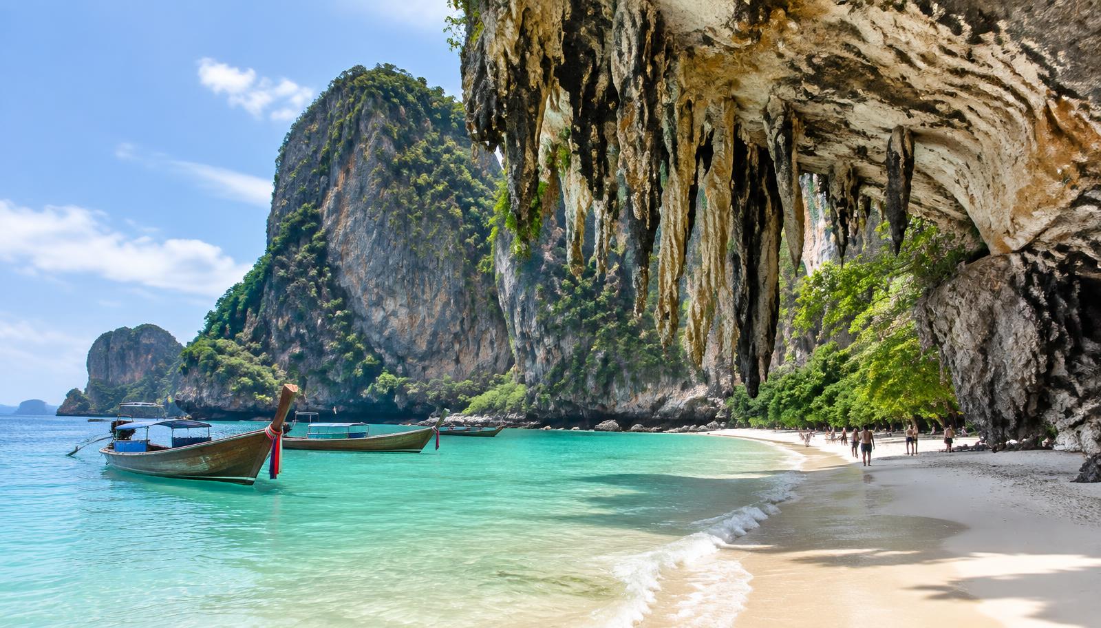 Railay's limestone cliffs with hanging rock formations above a white sand beach